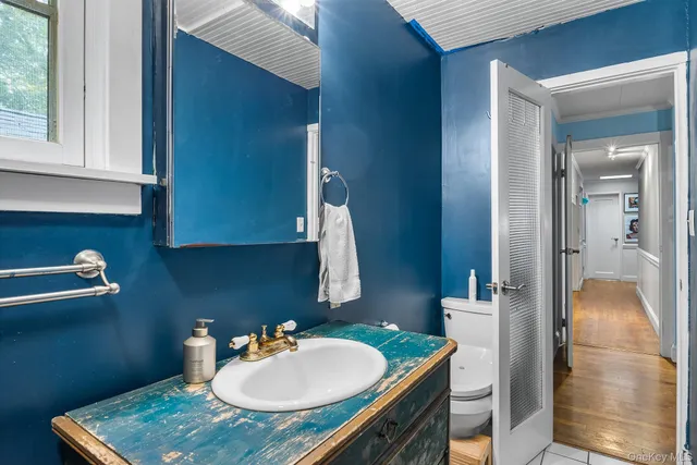 a view of a dining room with furniture a chandelier and kitchen view
