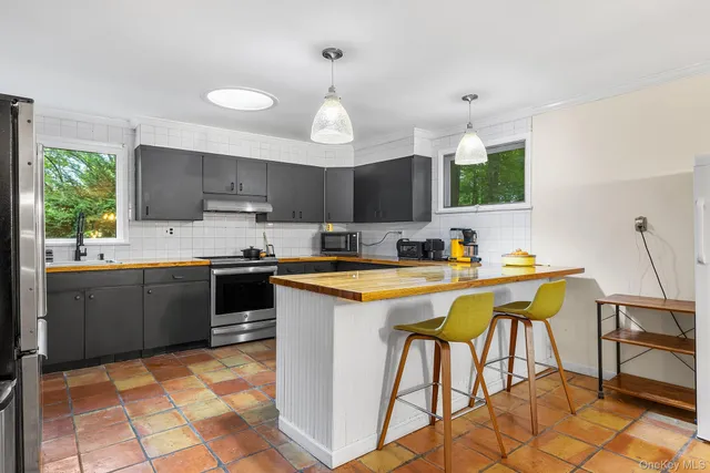 a view of a kitchen with a sink and a large window