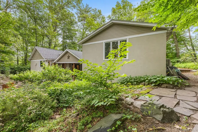 a white house with a yard and wooden fence