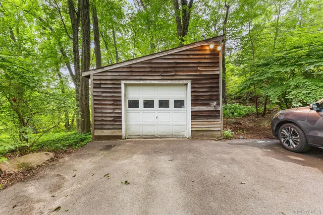 a view of a house with a yard and garage