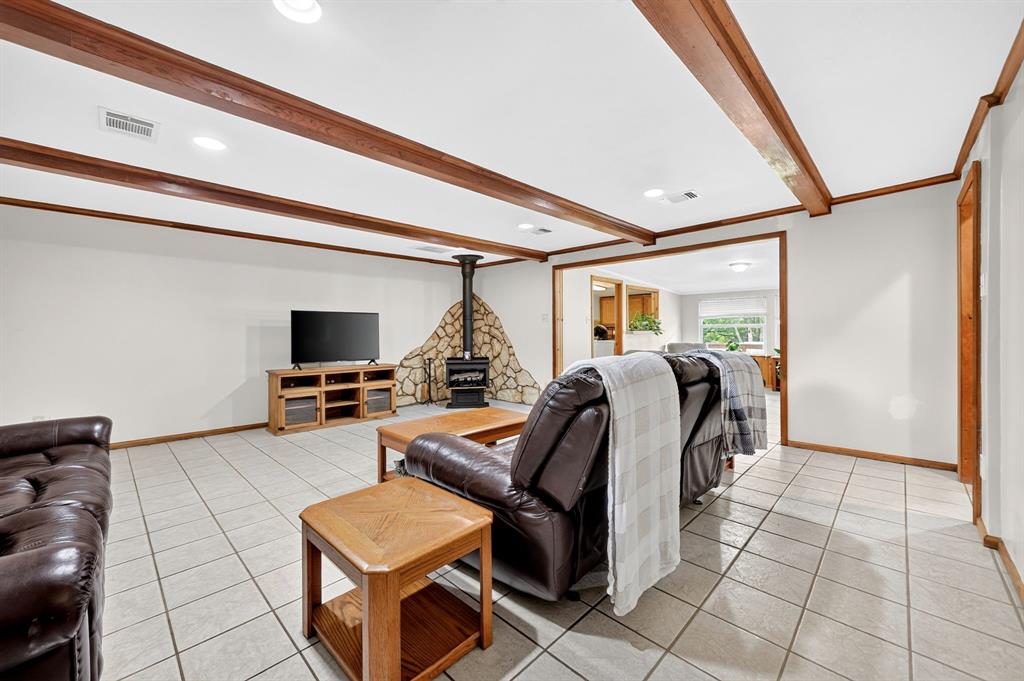 111 County Road 2806 Mabank, TX 75147 - Photo 10 of 34 Spacious living area featuring exposed wood beams, recessed lighting, and light-toned tile flooring