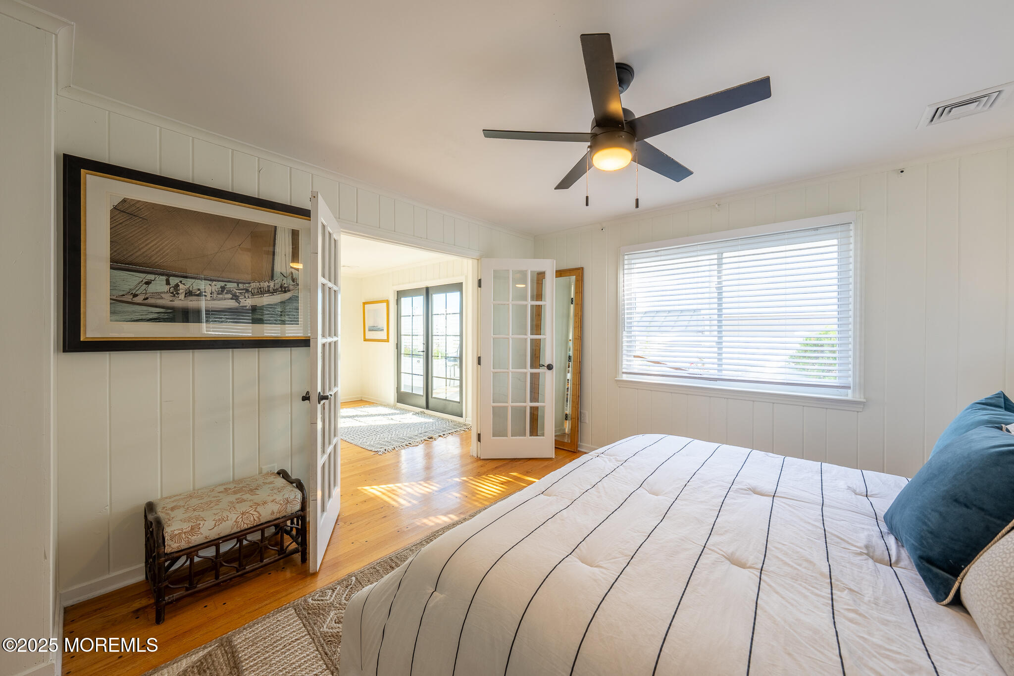 14 Falls Road Mantoloking, NJ 08738 - Photo 14 of 40 a bedroom with a bed and a chandelier