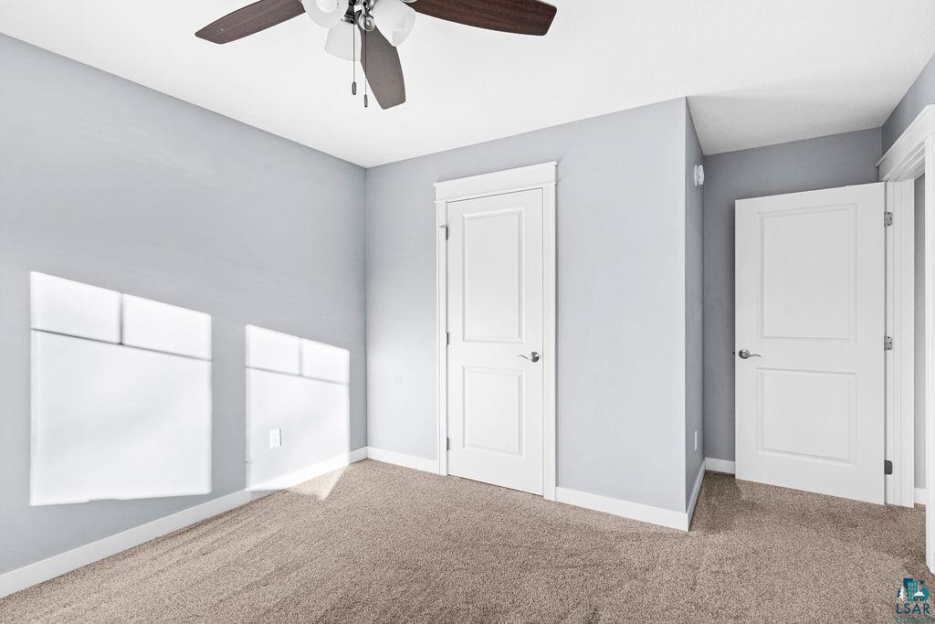 3879 Okerstrom Road Hermantown, MN 55811 - Photo 27 of 32 Unfurnished bedroom with carpet flooring and ceiling fan