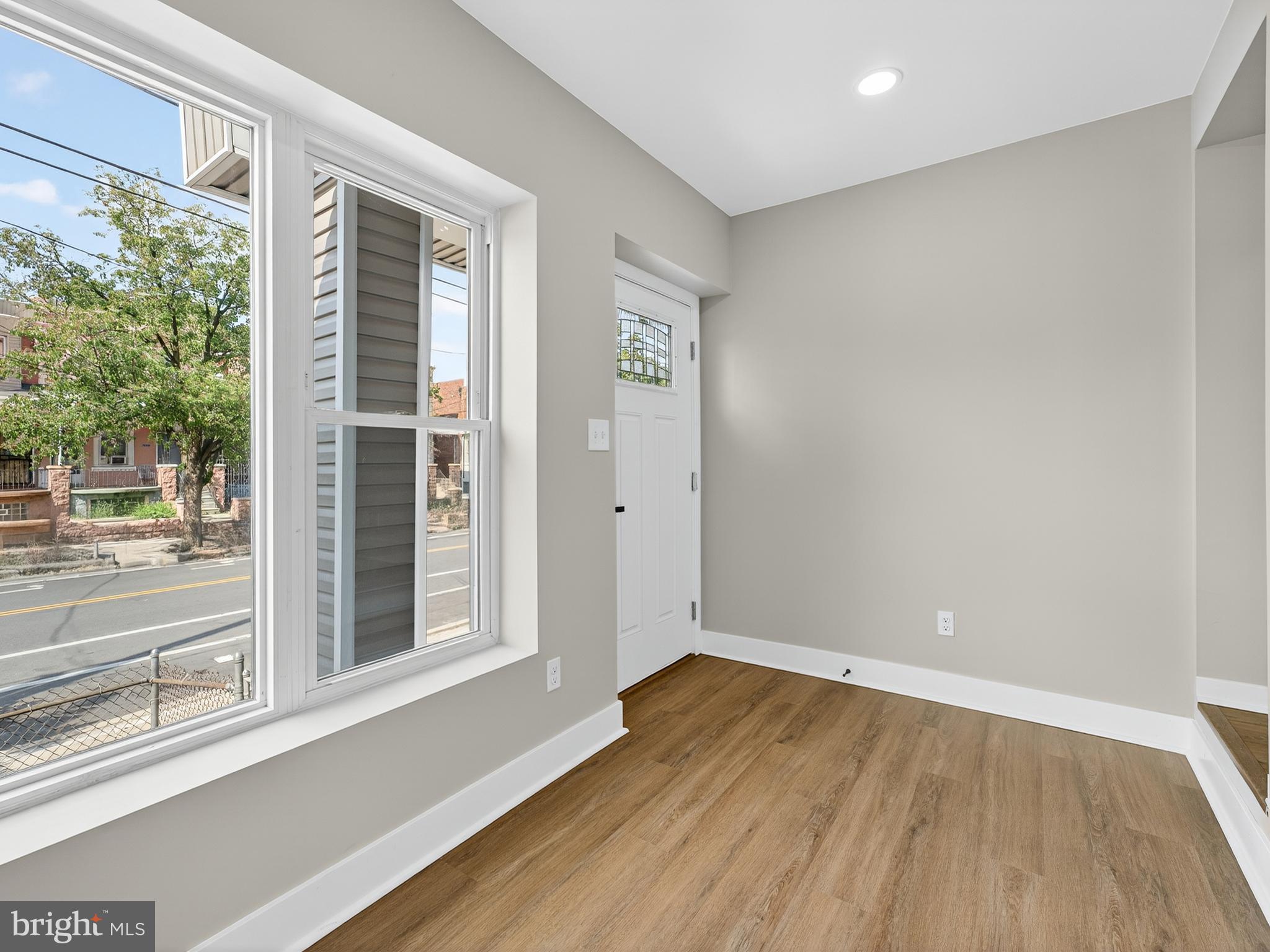 5736 Spruce Street Philadelphia, PA 19139 - Photo 11 of 32 an empty room with wooden floor and windows