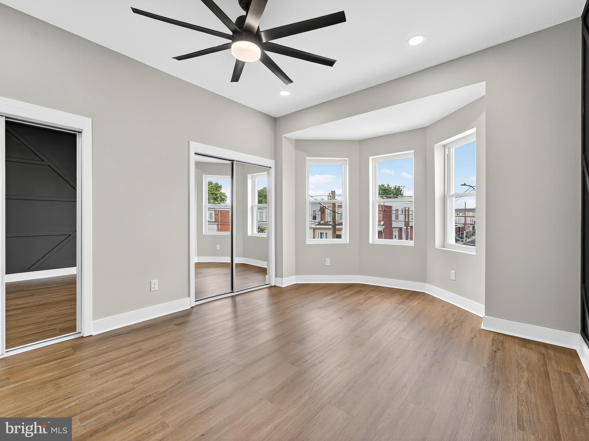 5736 Spruce Street Philadelphia, PA 19139 - Photo 14 of 32 an empty room with wooden floor chandelier and windows