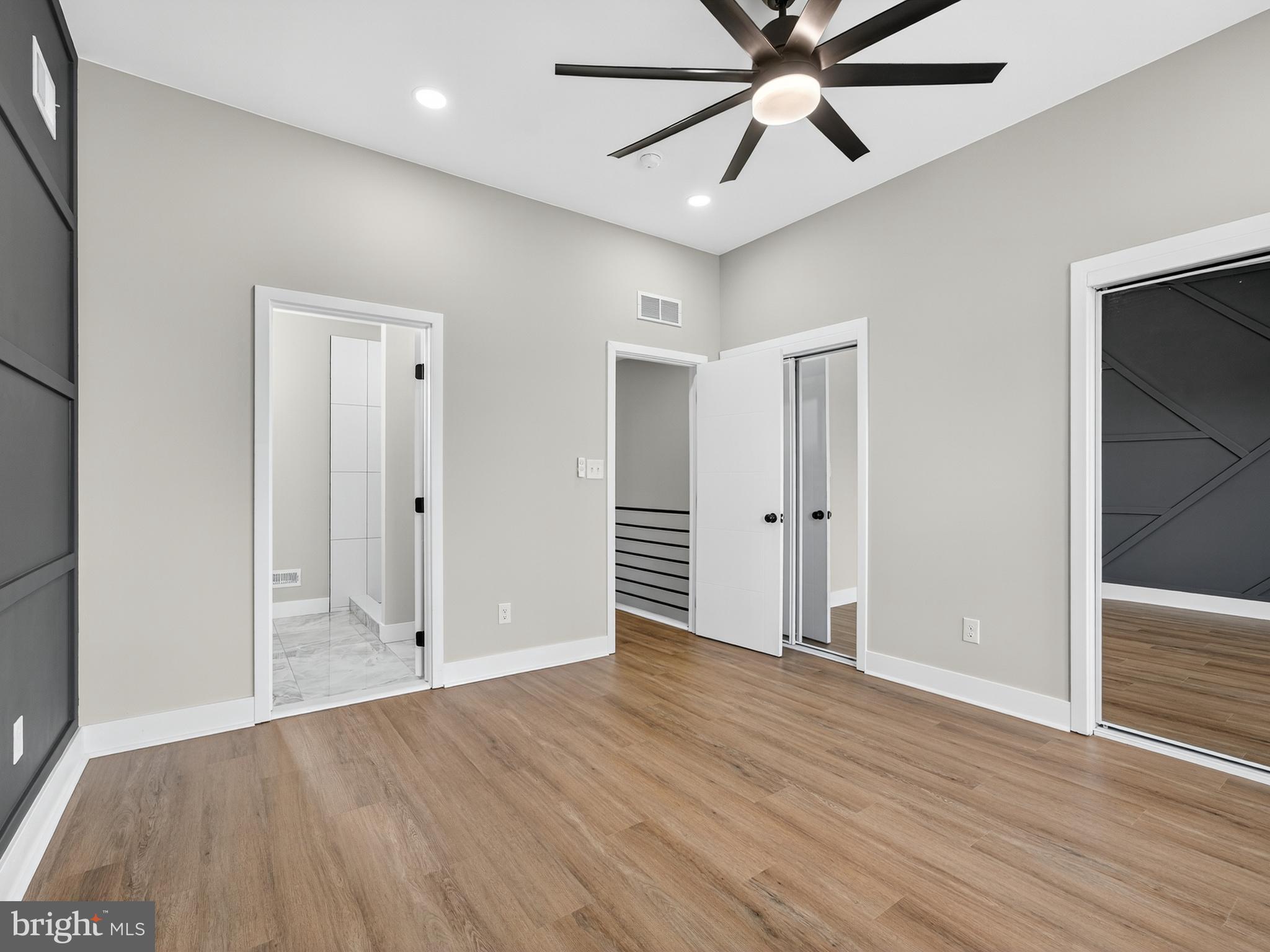 5736 Spruce Street Philadelphia, PA 19139 - Photo 15 of 32 an empty room with wooden floor and ceiling fan