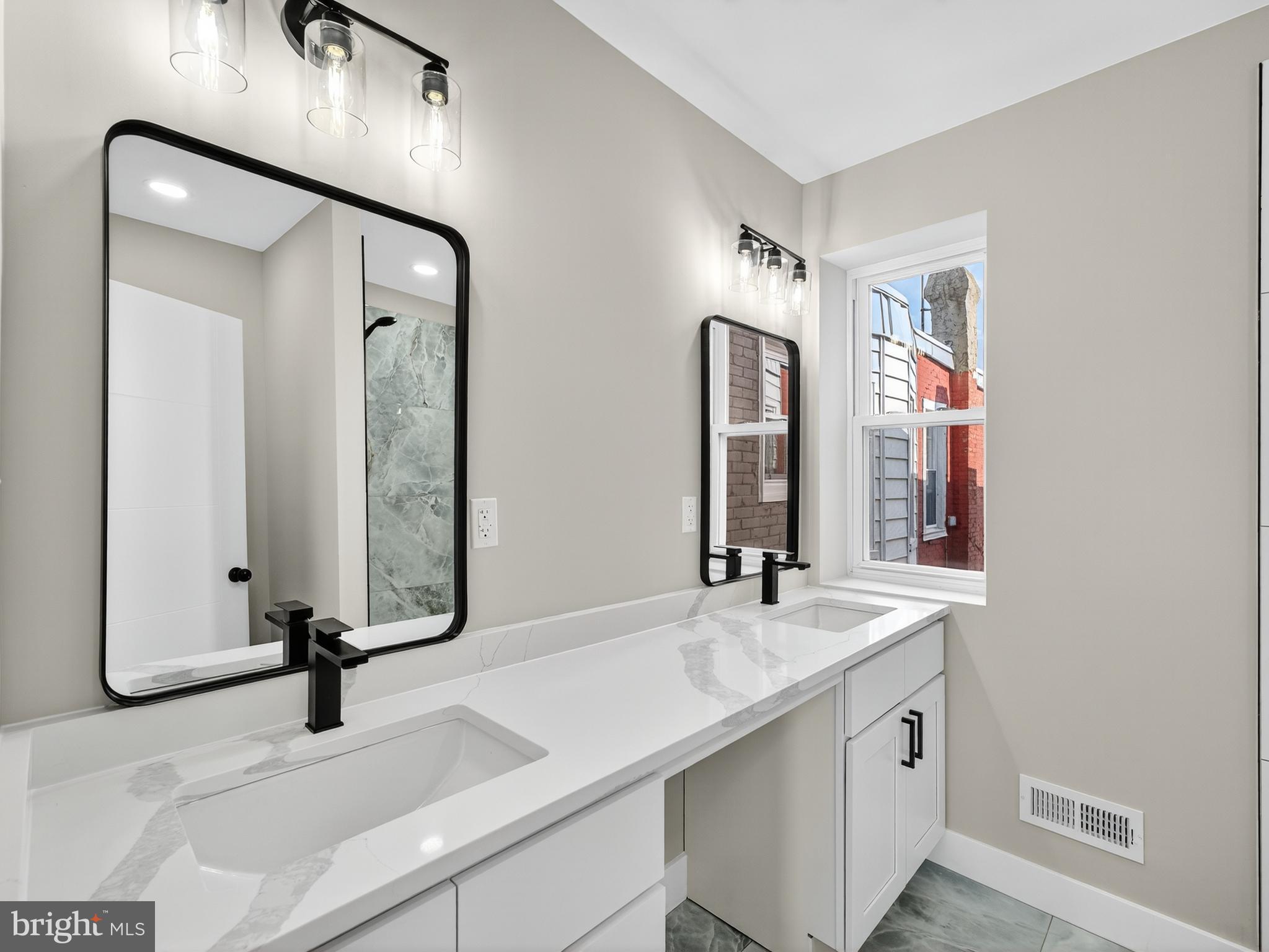 5736 Spruce Street Philadelphia, PA 19139 - Photo 16 of 32 a bathroom with a sink and a mirror