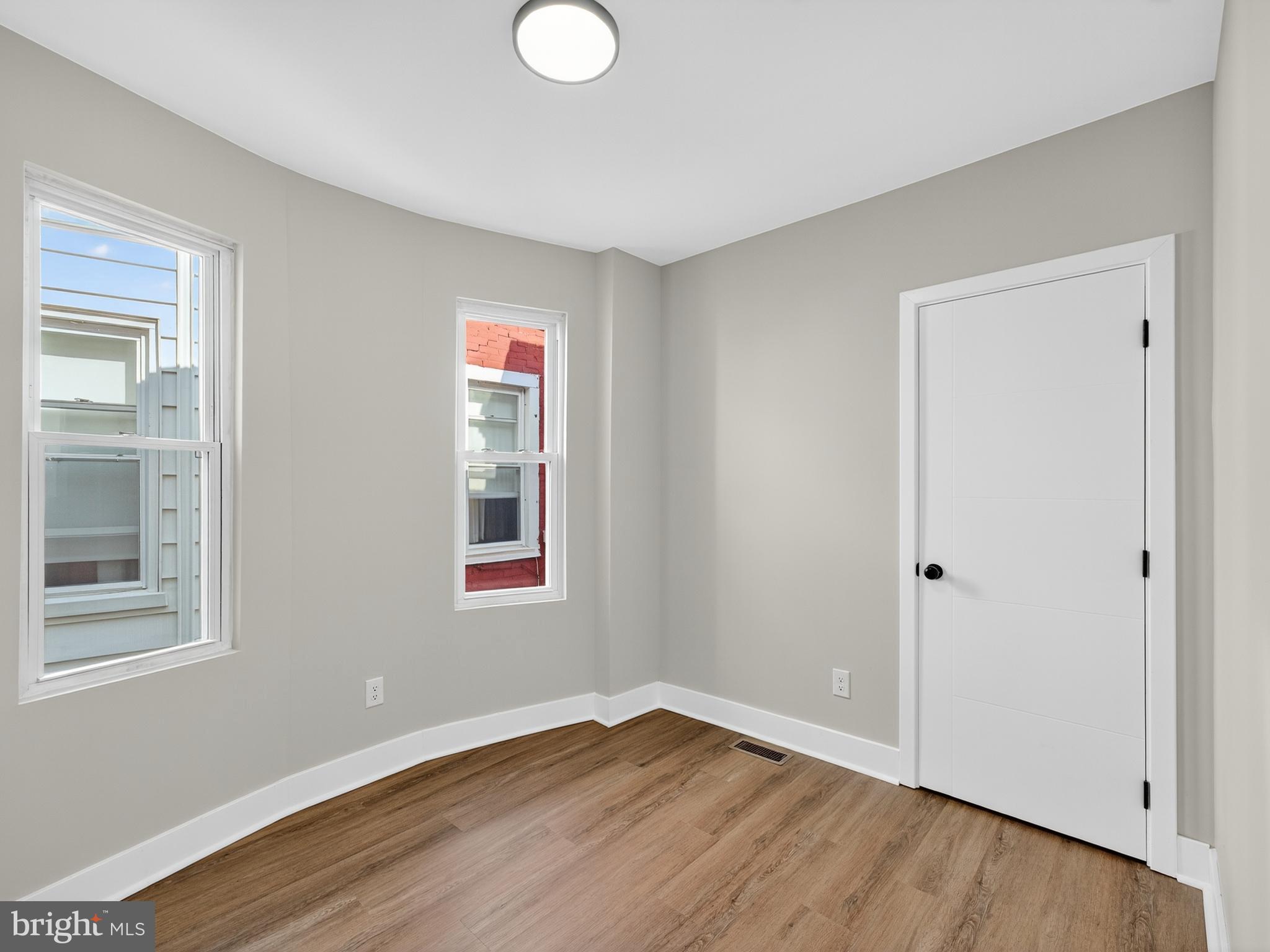 5736 Spruce Street Philadelphia, PA 19139 - Photo 19 of 32 a view of an empty room with wooden floor and a window