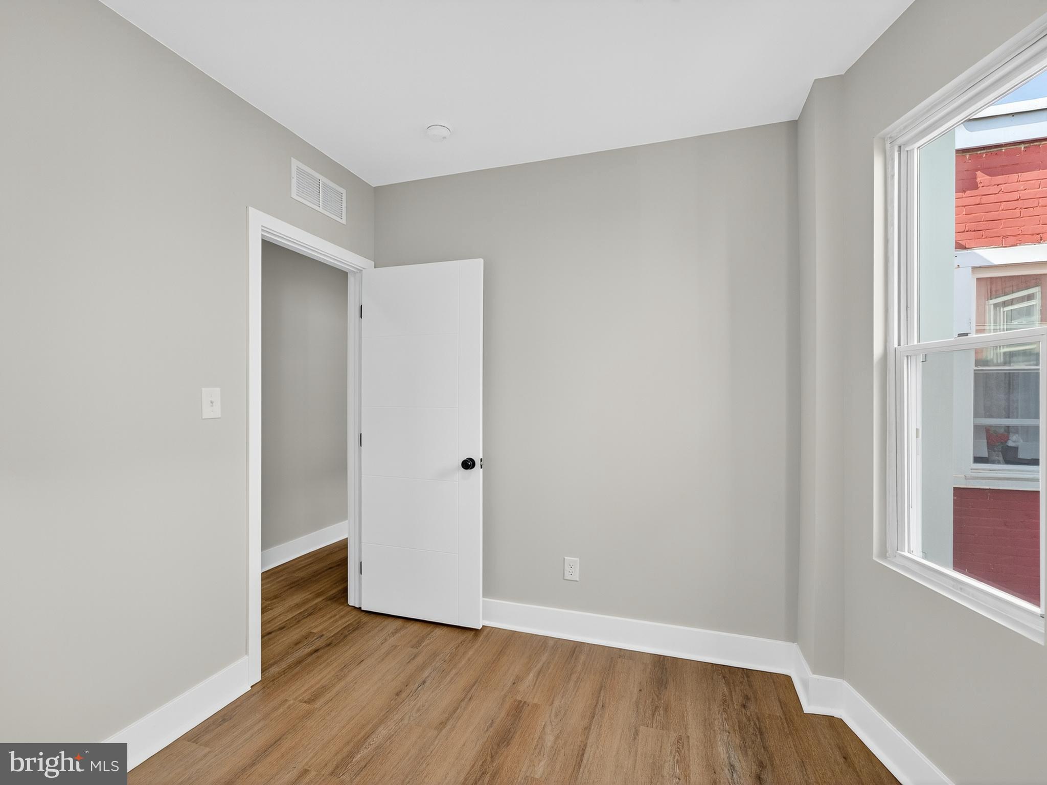 5736 Spruce Street Philadelphia, PA 19139 - Photo 20 of 32 a view of an empty room with wooden floor and a window