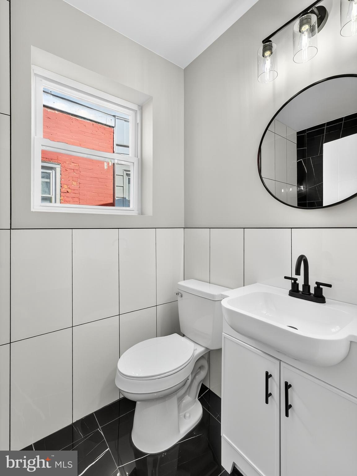 5736 Spruce Street Philadelphia, PA 19139 - Photo 21 of 32 a bathroom with a sink a toilet and a mirror