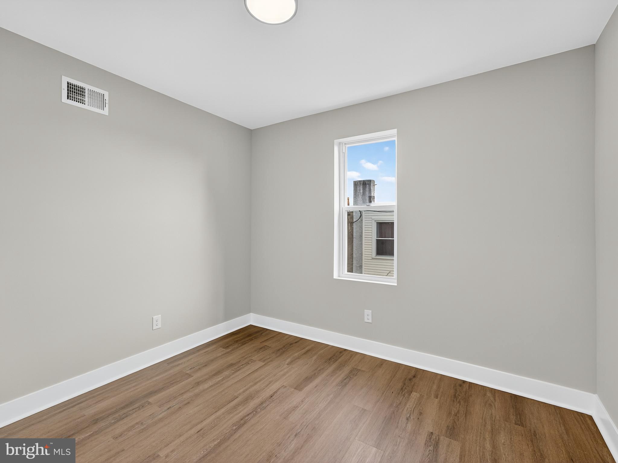 5736 Spruce Street Philadelphia, PA 19139 - Photo 23 of 32 a view of an empty room with wooden floor and a window