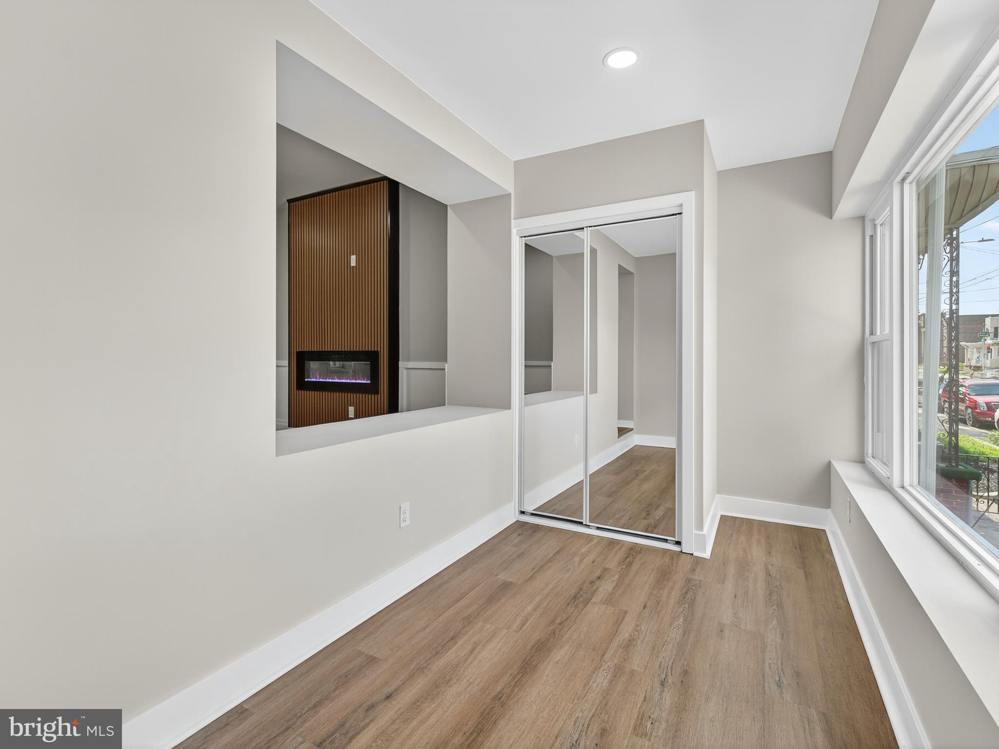 5736 Spruce Street Philadelphia, PA 19139 - Photo 10 of 32 an empty room with wooden floor and windows