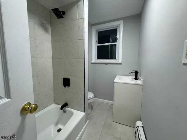 a bathroom with a sink and mirror with toilet