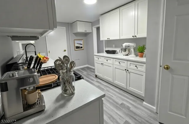 a kitchen with a sink appliances and cabinets