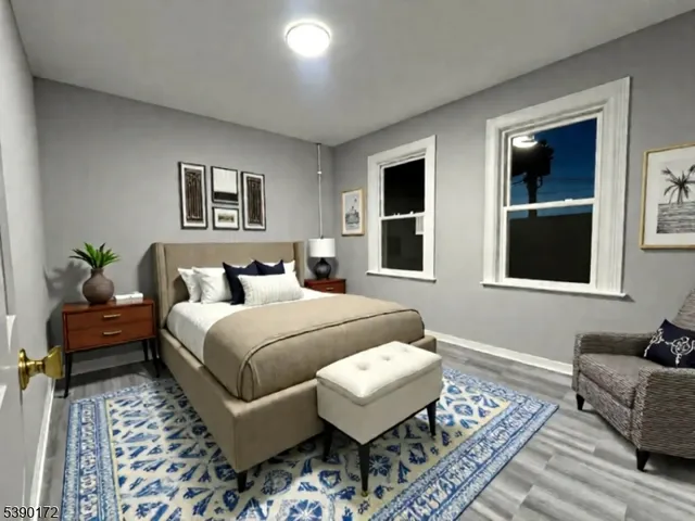 a bedroom with a bed wooden floor and a couch