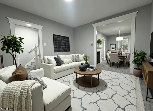 a living room with furniture and a potted plant