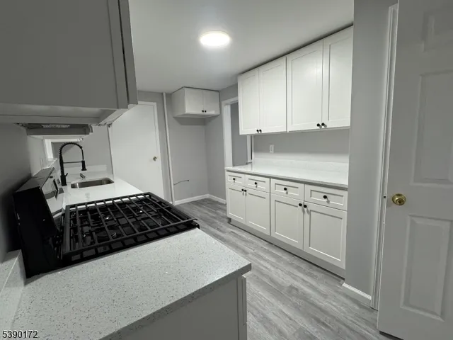 a kitchen with cabinets and stove
