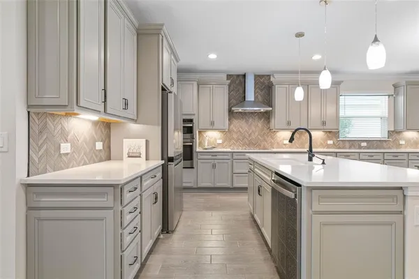 a kitchen with a refrigerator and cabinets