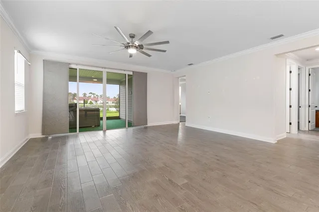 a kitchen with a sink a refrigerator and cabinets