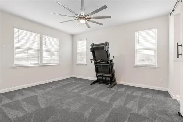 a view of a hallway with a white walls and stairs