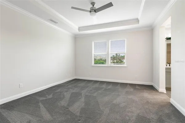 a view of an empty room with cabinet and mirrors