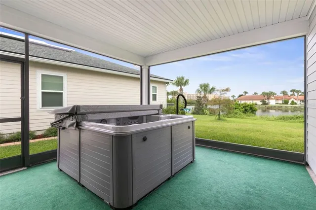 an aerial view of a house with a garden and lake view