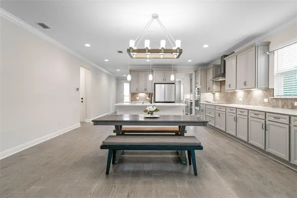 a kitchen with stainless steel appliances granite countertop a sink and dishwasher with white cabinets