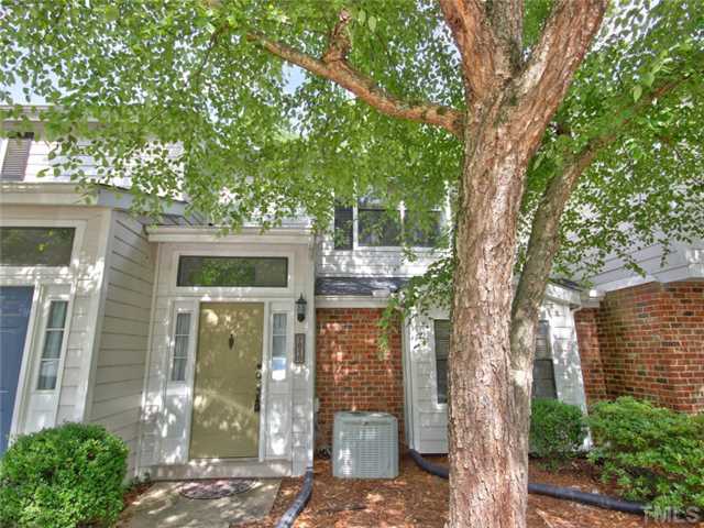 7618 Falcon Rest Circle, Unit 7618 Raleigh, NC 27615 - Photo 1 of 20 a front view of a house with a tree in front