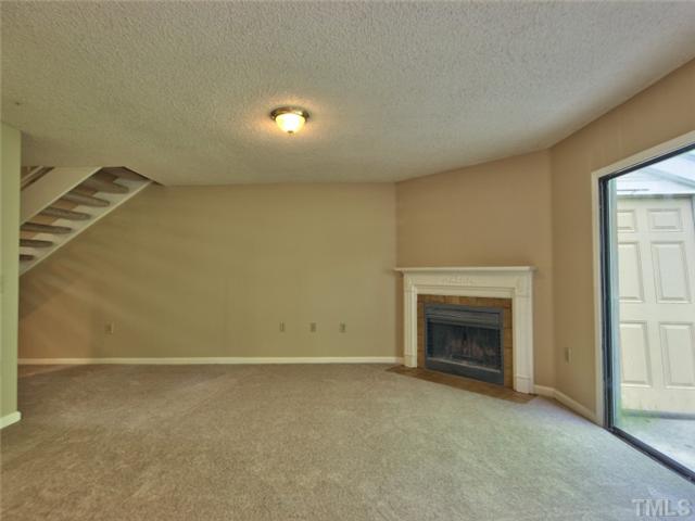 7618 Falcon Rest Circle, Unit 7618 Raleigh, NC 27615 - Photo 11 of 20 an empty room with a fireplace
