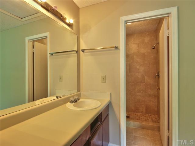 7618 Falcon Rest Circle, Unit 7618 Raleigh, NC 27615 - Photo 15 of 20 a bathroom with a granite countertop sink and a mirror