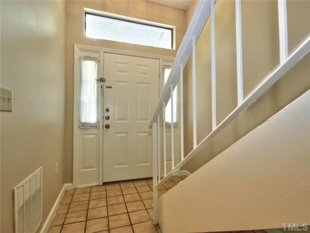7618 Falcon Rest Circle, Unit 7618 Raleigh, NC 27615 - Photo 4 of 20 a view of a hallway with wooden floor and staircase