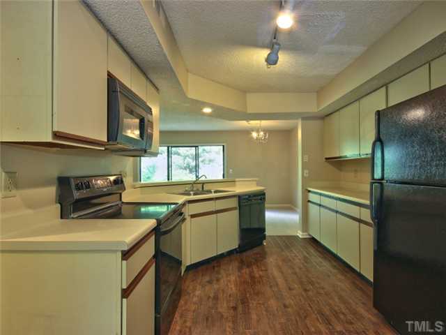 7618 Falcon Rest Circle, Unit 7618 Raleigh, NC 27615 - Photo 7 of 20 a kitchen with a sink appliances and cabinets