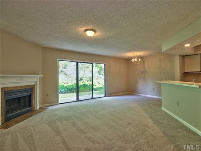 7618 Falcon Rest Circle, Unit 7618 Raleigh, NC 27615 - Photo 9 of 20 a view of an empty room with a fireplace and a window