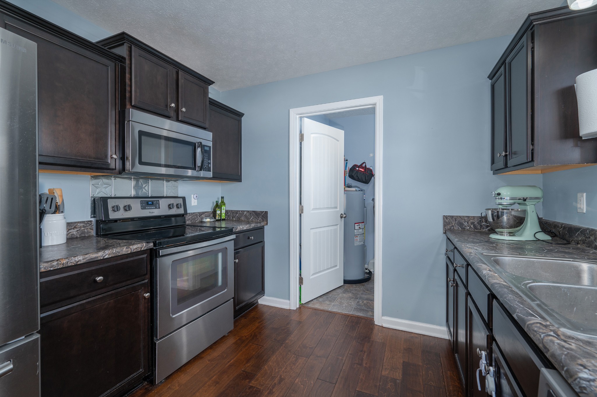 2995 Oak Grove Church Road Bethpage, TN 37022 - Photo 8 of 28 a kitchen with granite countertop wooden cabinets and stainless steel appliances