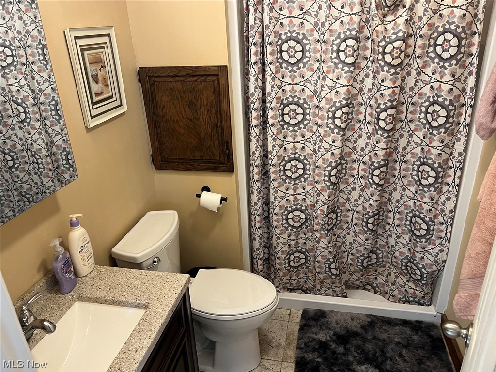 6950 Walker Road Walker, WV 26180 - Photo 10 of 22 Primary Bathroom featuring toilet, tile flooring, and vanity