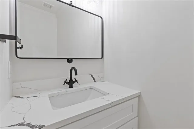 a bathroom with a sink and mirror