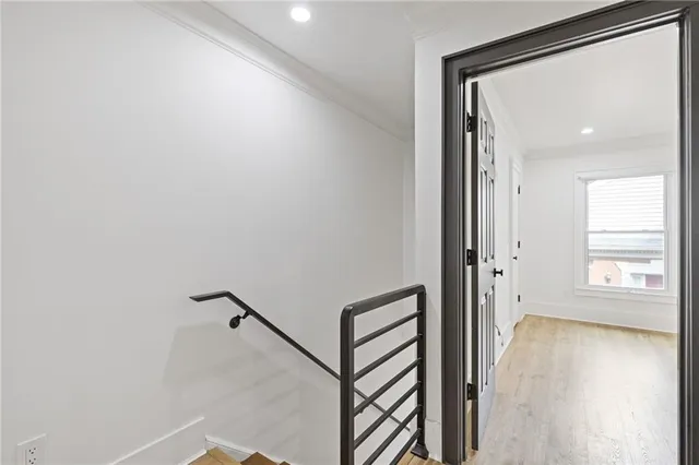 a view of a hallway with windows and wooden floor