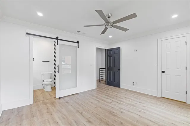 a view of a livingroom with wooden floor and white walls