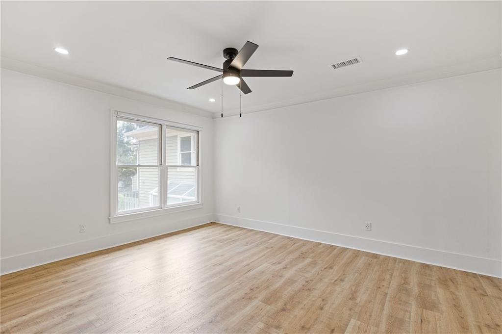 120 Mt Vernon Circle Atlanta, GA 30338 - Photo 24 of 44 an empty room with wooden floor fan and windows