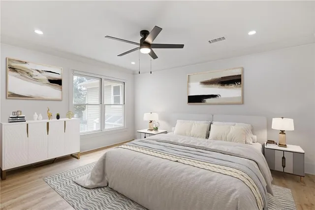 a bedroom with a large bed and a window