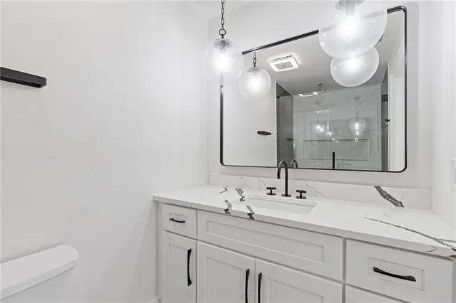 a bathroom with a sink vanity and a mirror