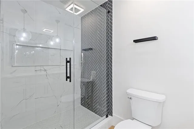 a bathroom with a shower and toilet