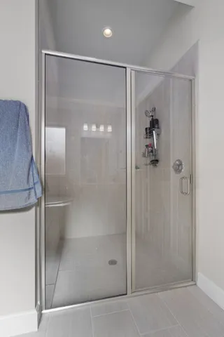 a bathroom with a glass shower door