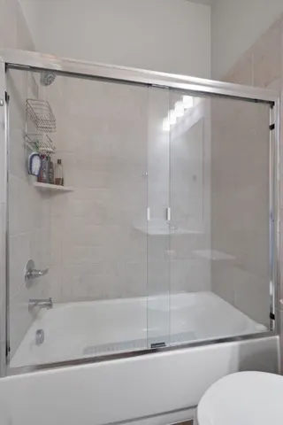 a bathroom with a shower and a bathtub