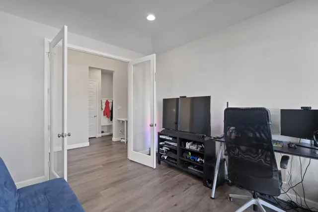 a view of a workspace with furniture and wooden floor