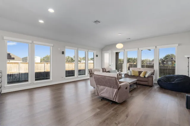 a living room with furniture and a large window
