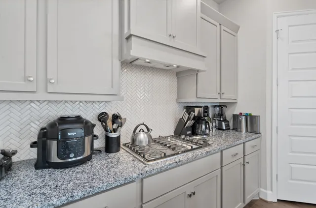 a kitchen with a sink and cabinets