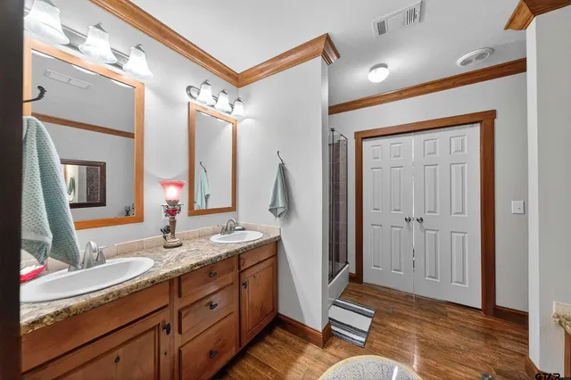 a spacious bathroom with a double vanity sink and a mirror