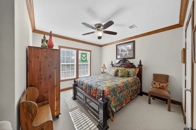 a bedroom with a bed couch and window