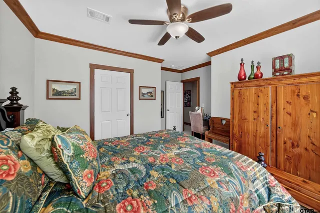 a bedroom with bed and a chandelier